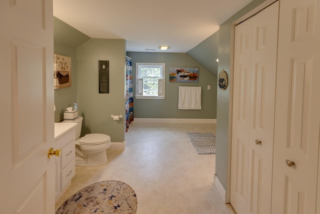 104 Champagne Cir, Campton, NH 03223 - full bathroom featuring lofted ceiling, toilet, baseboards, and a shower with shower curtain