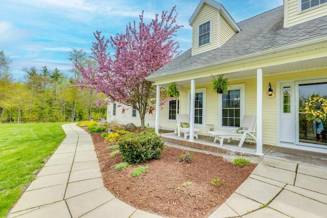 104 Champagne Cir, Campton, NH 03223 - property entrance with covered porch, a shingled roof, and a yard