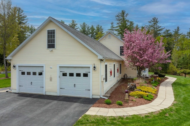 104 Champagne Cir, Campton, NH 03223 - view of property exterior with a garage and asphalt driveway