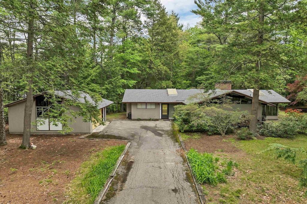 25 Wendover Way, Bedford, NH 03110 - view of front of property with driveway, an outbuilding, and a chimney