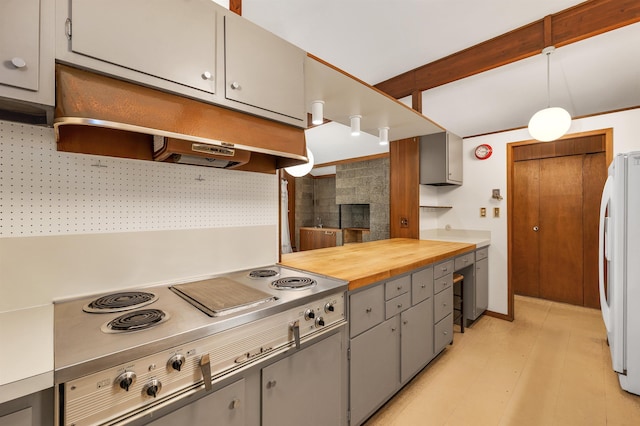 25 Wendover Way, Bedford, NH 03110 - kitchen with gray cabinetry, freestanding refrigerator, under cabinet range hood, stainless steel cooktop, and a fireplace
