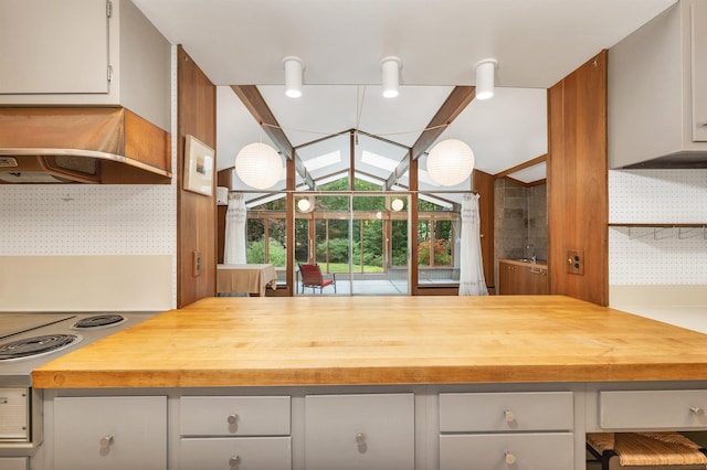 25 Wendover Way, Bedford, NH 03110 - kitchen with butcher block countertops, range hood, gray cabinets, and vaulted ceiling