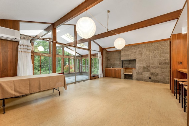 25 Wendover Way, Bedford, NH 03110 - living area with beam ceiling, a wall unit AC, high vaulted ceiling, a wall of windows, and a fireplace
