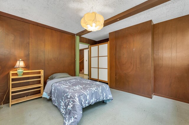 25 Wendover Way, Bedford, NH 03110 - bedroom featuring tile patterned floors, wooden walls, and a chandelier