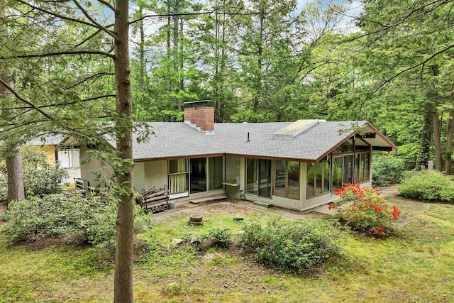 25 Wendover Way, Bedford, NH 03110 - rear view of property featuring a shingled roof, a sunroom, and a chimney
