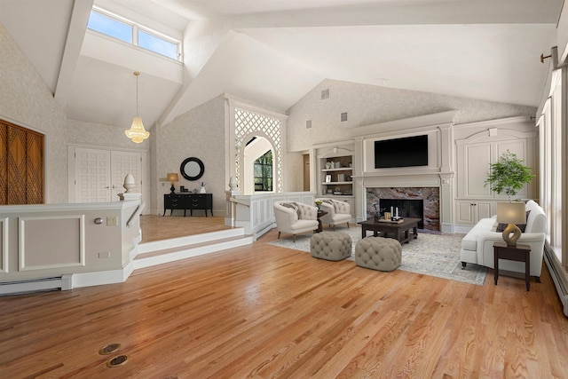 43 Sterling Pl, Bow, NH 03304 - living area featuring healthy amount of natural light, a premium fireplace, wood finished floors, and high vaulted ceiling