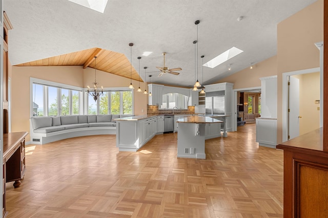 43 Sterling Pl, Bow, NH 03304 - kitchen with a skylight, stainless steel dishwasher, a center island, a sink, and decorative light fixtures