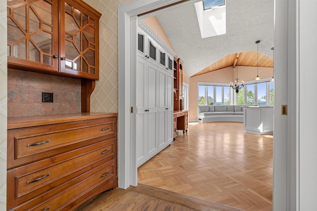43 Sterling Pl, Bow, NH 03304 - hall with a chandelier, vaulted ceiling, a skylight, and baseboards