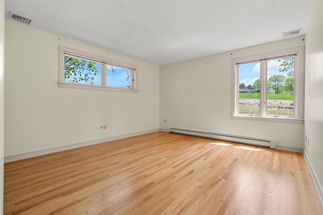 43 Sterling Pl, Bow, NH 03304 - unfurnished room with a baseboard heating unit, plenty of natural light, wood finished floors, and baseboards