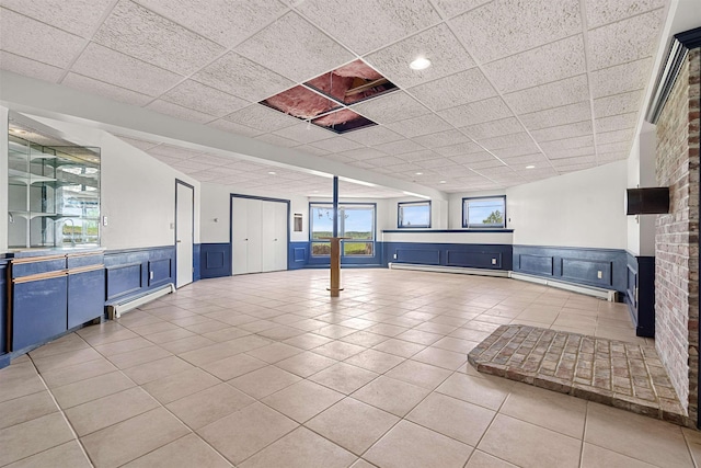 43 Sterling Pl, Bow, NH 03304 - spare room featuring wainscoting, a paneled ceiling, light tile patterned flooring, a decorative wall, and a baseboard heating unit