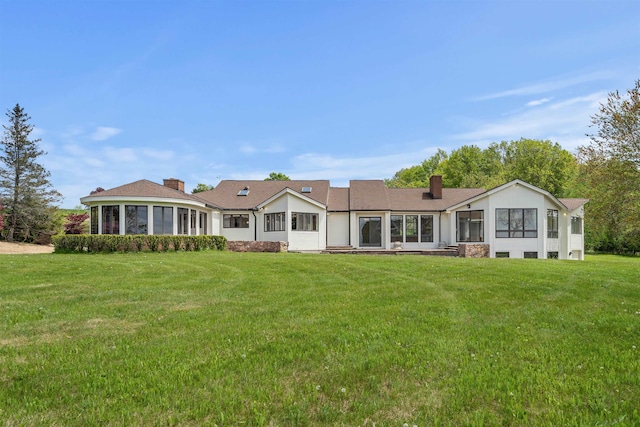 43 Sterling Pl, Bow, NH 03304 - back of property featuring a chimney, a sunroom, and a yard