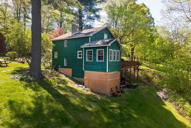 141 Hemmsted Cir # 6, Castleton, VT 05732 - view of side of home with a chimney, a yard, and a wooden deck