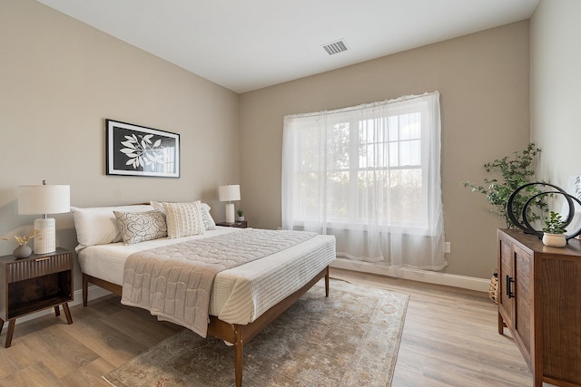 10100 S Willow St Unit 114, Manchester, NH 03103 - bedroom with light wood-style floors and baseboards