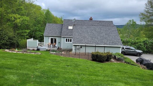 45 Deacon Willey Rd, Campton, NH 03223 - back of house with a shingled roof, a chimney, a wooden deck, a lawn, and a forest view
