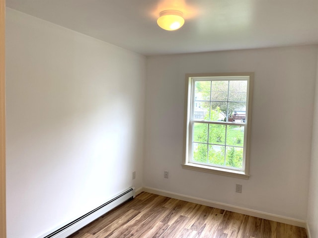 32 Henry Taylor St, Salem, NH 03079 - empty room with a baseboard radiator, light wood finished floors, and baseboards
