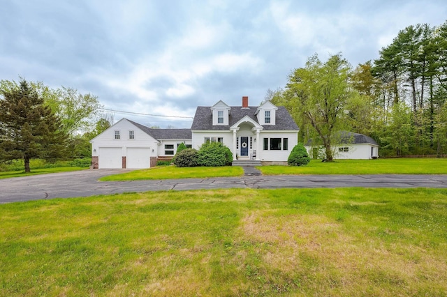 25 Kings Hwy, Middleton, NH 03887 - view of front of home featuring driveway, a front lawn, a chimney, and an attached garage
