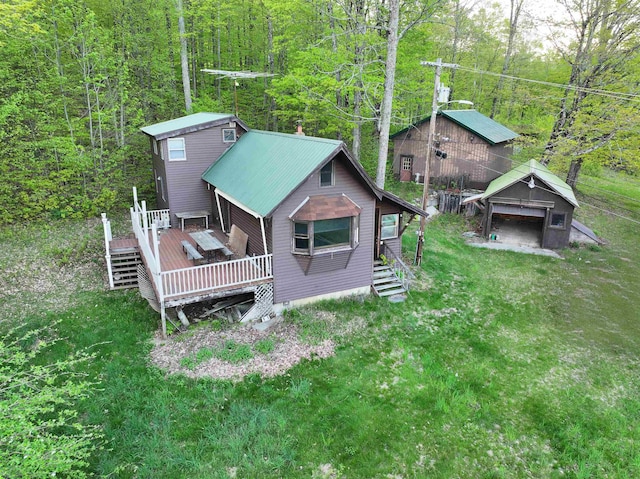 aerial view of property and surrounding area featuring a forest