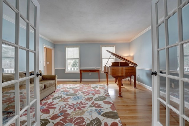 155 Middle Rd, Brentwood, NH 03833 - living area with french doors, ornamental molding, baseboards, and light wood-type flooring