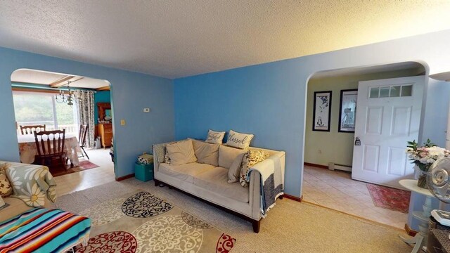 1862 Hooksett Rd, Hooksett, NH 03106 - living area with arched walkways, a textured ceiling, baseboard heating, and baseboards