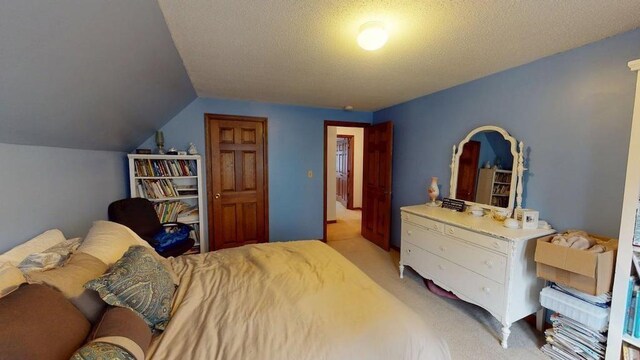 1862 Hooksett Rd, Hooksett, NH 03106 - bedroom with light colored carpet, vaulted ceiling, and a textured ceiling