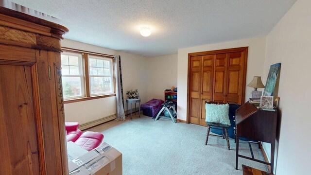 1862 Hooksett Rd, Hooksett, NH 03106 - sitting room featuring carpet floors, a baseboard heating unit, baseboards, and a textured ceiling
