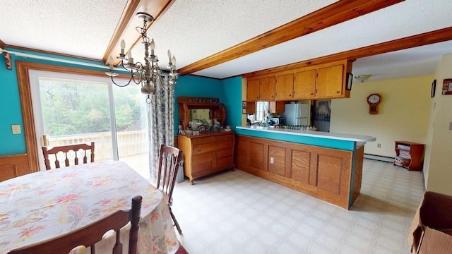 1862 Hooksett Rd, Hooksett, NH 03106 - kitchen with freestanding refrigerator, a chandelier, brown cabinetry, light floors, and a baseboard radiator