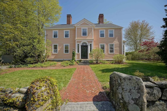 520 Washington Rd, Rye, NH 03870 - view of front facade featuring a chimney and a front yard