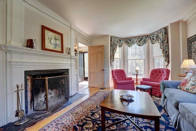 520 Washington Rd, Rye, NH 03870 - living area featuring a fireplace with flush hearth, crown molding, and light wood-style flooring