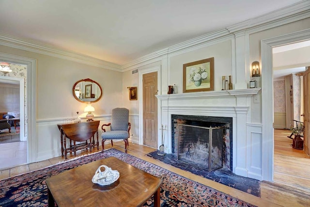 520 Washington Rd, Rye, NH 03870 - living room with a decorative wall, a fireplace with flush hearth, ornamental molding, light wood finished floors, and a wainscoted wall