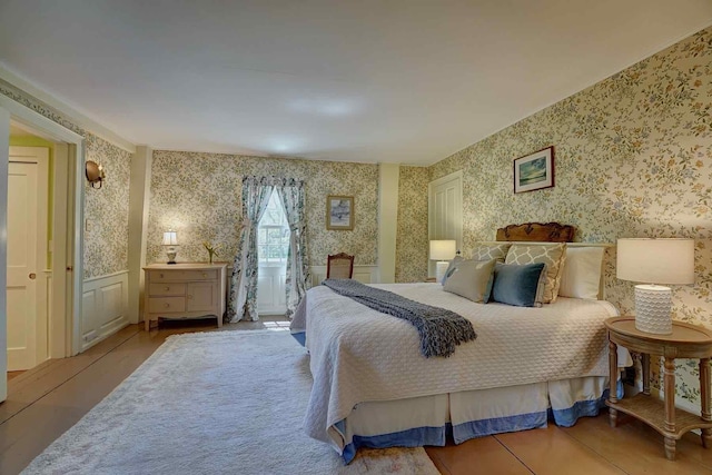 520 Washington Rd, Rye, NH 03870 - bedroom with wallpapered walls, wood finished floors, and wainscoting