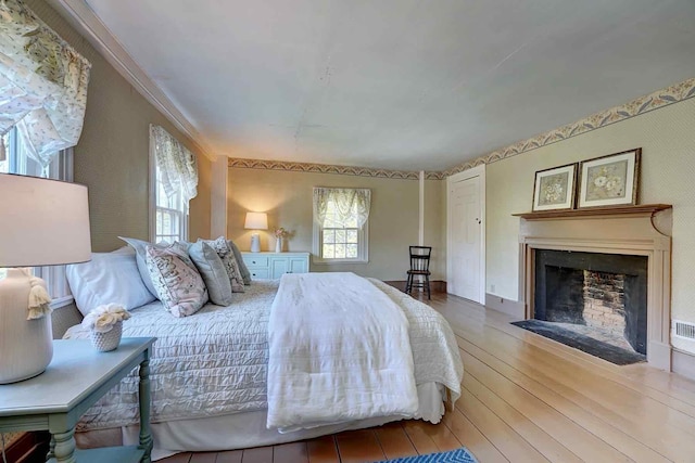 520 Washington Rd, Rye, NH 03870 - bedroom with wood-type flooring and a fireplace with flush hearth