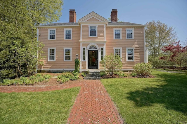 520 Washington Rd, Rye, NH 03870 - view of front of house with a chimney and a front lawn