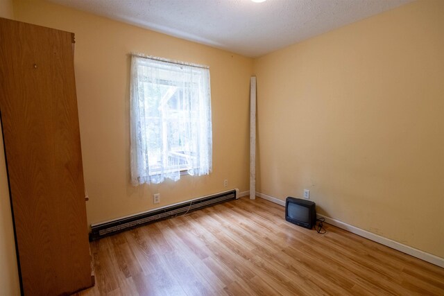 11 Henry Dr, Effingham, NH 03882 - unfurnished room featuring baseboard heating, wood finished floors, and baseboards