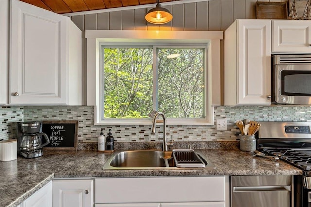 235 Pleasant View Dr, North Hero, VT 05474 - kitchen featuring stainless steel appliances, a sink, decorative backsplash, white cabinets, and wood ceiling