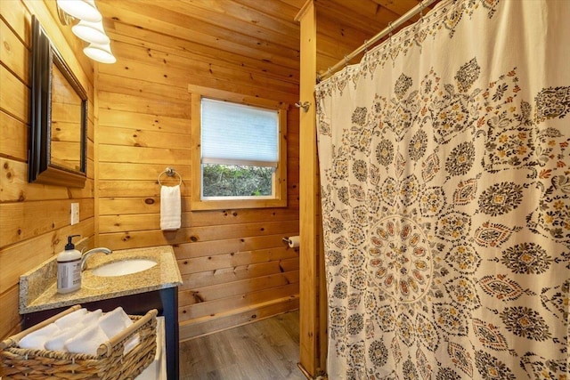 235 Pleasant View Dr, North Hero, VT 05474 - bathroom with wood ceiling, wood finished floors, vanity, wood walls, and a shower with curtain