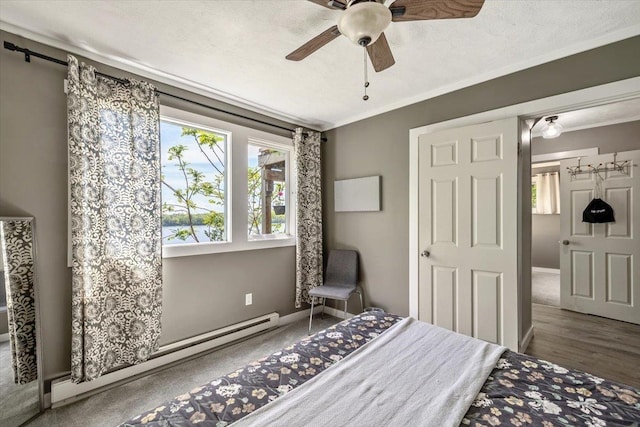 235 Pleasant View Dr, North Hero, VT 05474 - bedroom featuring a baseboard heating unit, ornamental molding, a ceiling fan, baseboards, and wood finished floors