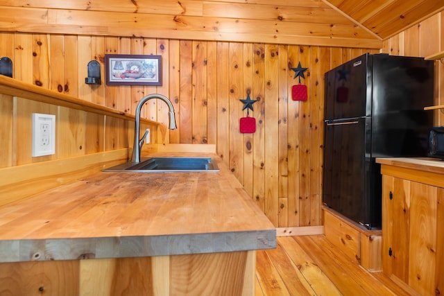 239 NE Pond Rd, Milton, NH 03851 - kitchen featuring a sink, freestanding refrigerator, wooden counters, light wood finished floors, and vaulted ceiling