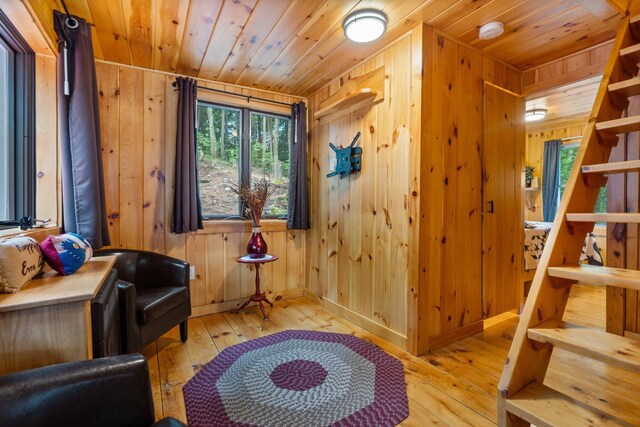239 NE Pond Rd, Milton, NH 03851 - living area featuring wood ceiling, hardwood / wood-style flooring, wooden walls, and stairs