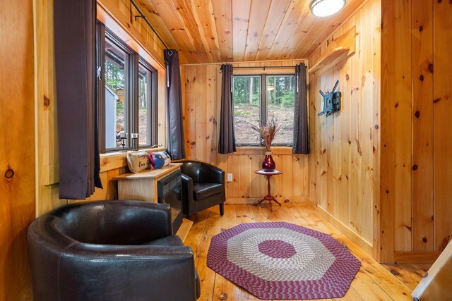 239 NE Pond Rd, Milton, NH 03851 - living area with hardwood / wood-style flooring, healthy amount of natural light, wooden ceiling, and wood walls
