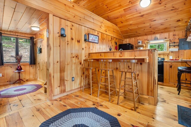 239 NE Pond Rd, Milton, NH 03851 - bar with light wood finished floors, wood ceiling, wooden walls, vaulted ceiling, and range with gas cooktop