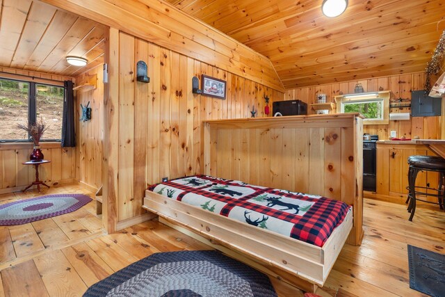 239 NE Pond Rd, Milton, NH 03851 - bedroom featuring light wood-style flooring, wood ceiling, lofted ceiling, wooden walls, and electric panel