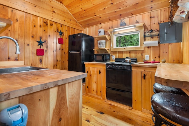 239 NE Pond Rd, Milton, NH 03851 - kitchen with black appliances, wooden counters, a sink, vaulted ceiling, and electric panel