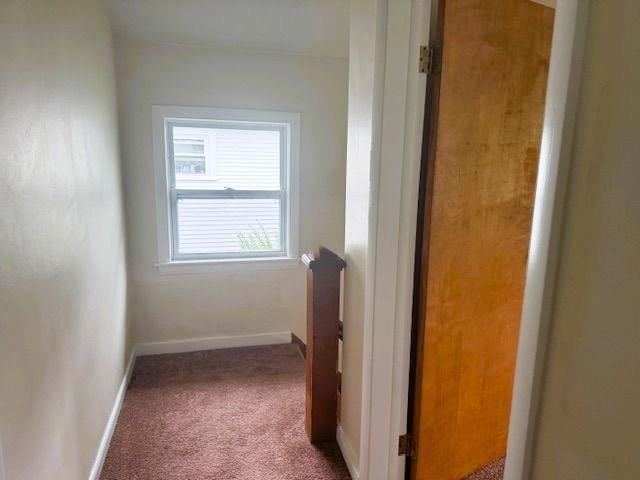 54 E Center St, Rutland City, VT 05701 - hallway featuring carpet floors and baseboards