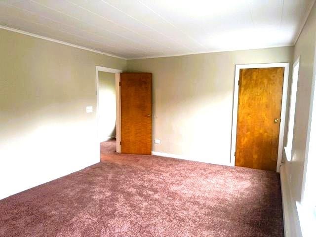54 E Center St, Rutland City, VT 05701 - carpeted empty room featuring crown molding