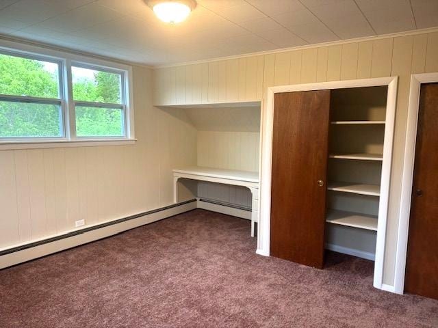 54 E Center St, Rutland City, VT 05701 - unfurnished bedroom featuring carpet flooring, a baseboard heating unit, and wood walls