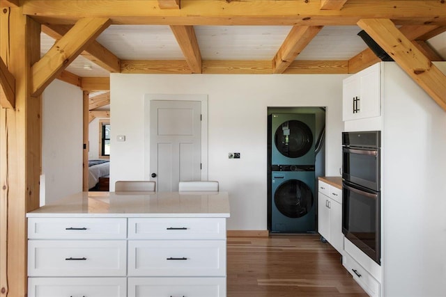 64 Atkins Farm Rd, Ferrisburgh, VT 05456 - washroom featuring stacked washer / dryer, dark wood-style floors, and wooden ceiling