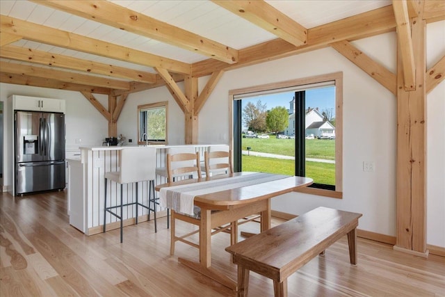 64 Atkins Farm Rd, Ferrisburgh, VT 05456 - dining space featuring light wood-style floors, beamed ceiling, and baseboards