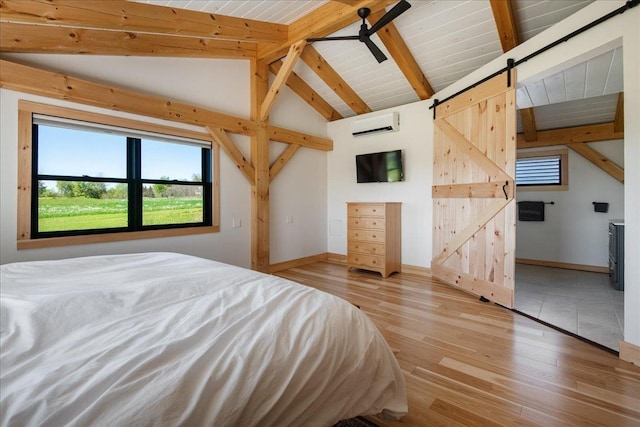 64 Atkins Farm Rd, Ferrisburgh, VT 05456 - bedroom featuring a barn door, light wood-style floors, a wall unit AC, and baseboards