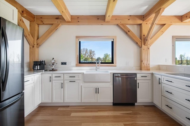 64 Atkins Farm Rd, Ferrisburgh, VT 05456 - kitchen with appliances with stainless steel finishes, a sink, beam ceiling, white cabinetry, and light countertops