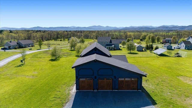 64 Atkins Farm Rd, Ferrisburgh, VT 05456 - view of outdoor structure featuring a garage, a mountain view, and asphalt driveway